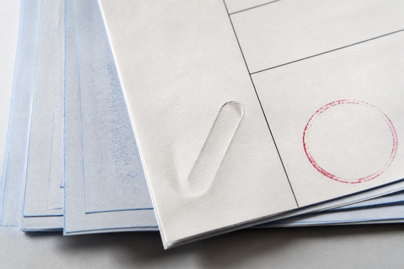 Carbon-copy engineering form with a faint circular imprint