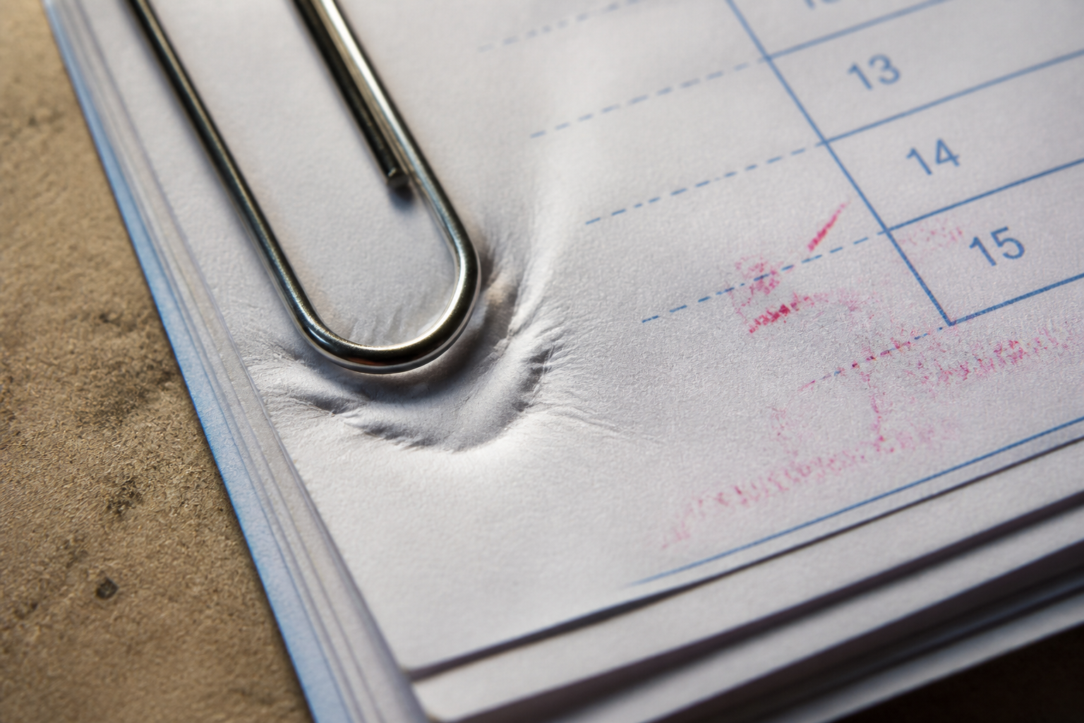 Paperclip pressure dent in a stack of thin engineering forms